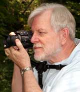 Photographer using Table Top Tripod as Chest Pod